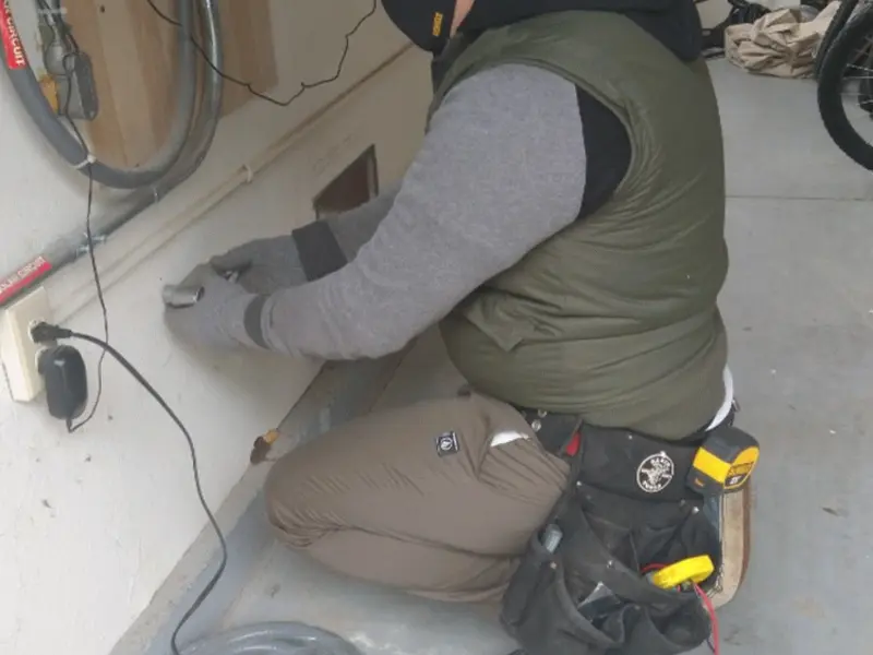 Electrician performing outlet wiring in a Upper Deerfield garage